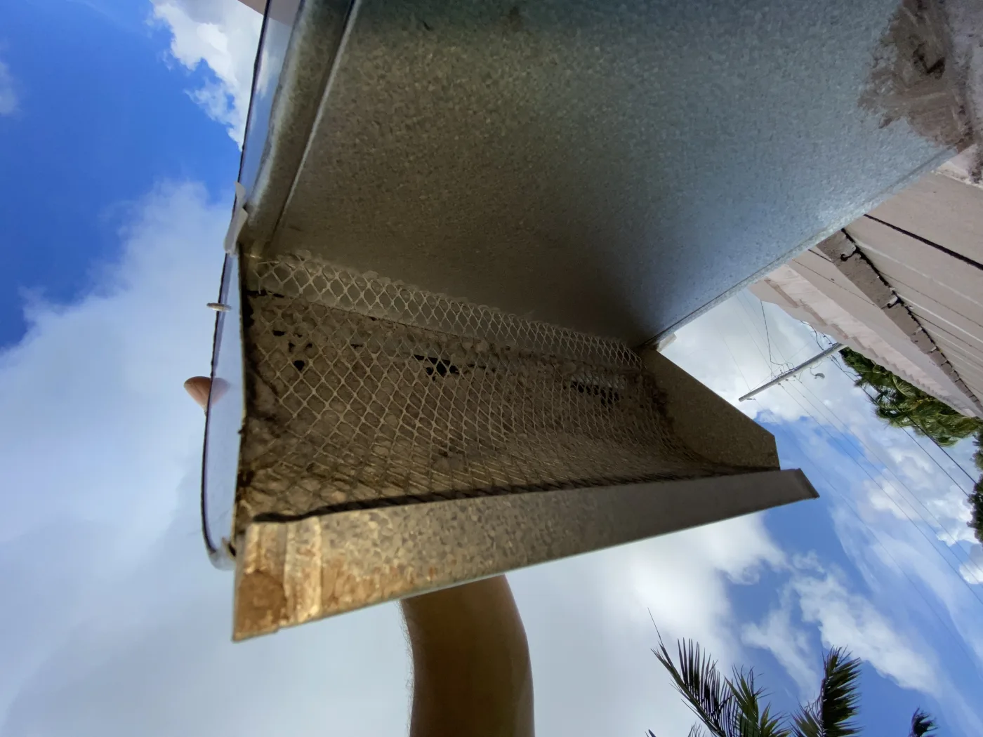 Roof-exit dryer vent restriction checked before airflow cleaning.