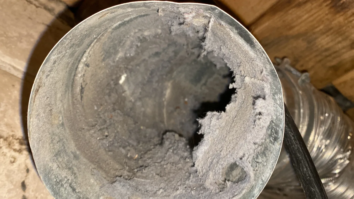 Dryer vent cleaning access point before service.