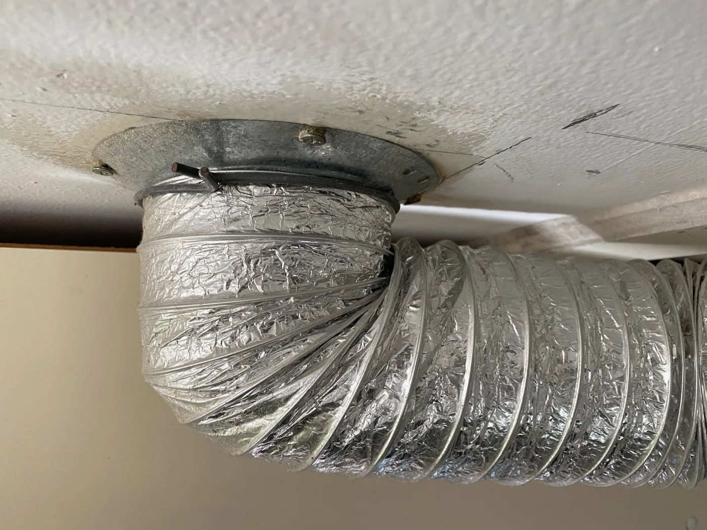 Long dryer vent run checked for lint restriction and airflow loss.