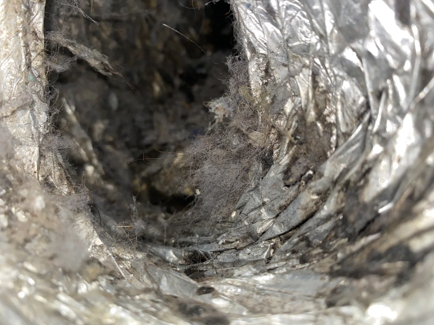 Lint and debris along the inside of a flexible foil dryer duct